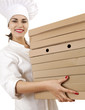 chef woman in white uniform and hat with boxes of pizza