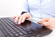 Business woman with credit card, typing