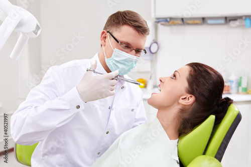 Photo: The dentist makes an injection at the clinic The dentist makes an injection at the clinic