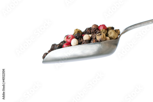 Photo: silver spoon with pepper on white background silver spoon with pepper on white background