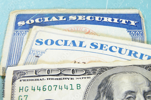 Photo: closeup of US money and Social Security cards closeup of US money and Social Security cards