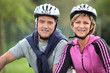 Photo: Senior couple on a bicycle with helmet Senior couple on a bicycle with helmet