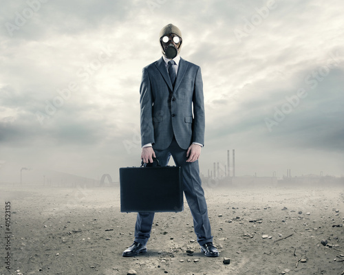 Photo: doomsday: portrait of businessman in a gas mask with suitcase doomsday: portrait of businessman in a gas mask with suitcase