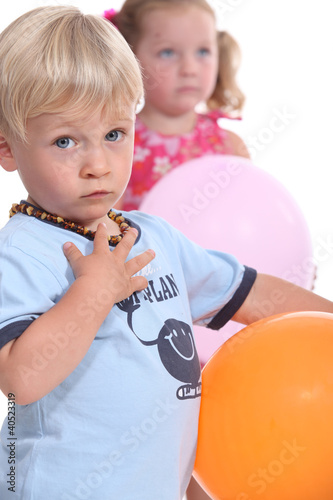 Photo: Young boy and his friend playing with balloons Young boy and his friend playing with balloons
