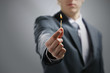 Foto: Business man hand holding a burning match Business man hand holding a burning match