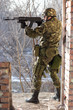 Soldier standing near wall with a gun