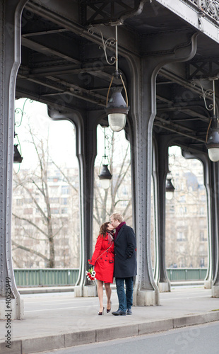 Photo: Romantic couple kissing on the Bir-Hakeim bridge Romantic couple kissing on the Bir-Hakeim bridge