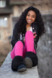 Portrait of a happy young african american teenage girl listenin