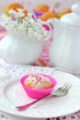 Cupcake with teapot and jug at background