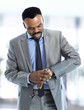 Young business man checking his watch