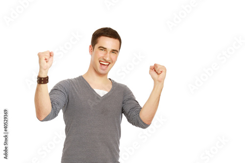 Photo: A handsome man showing yes expression on white background A handsome man showing yes expression on white background