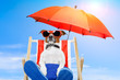 dog sunbathing on a deck chair