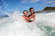 Photo: Cheerful couple enjoying the waves Cheerful couple enjoying the waves