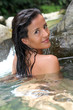 Attractive brunette woman taking a bath in river