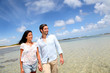Cheerful couple walking by the sea