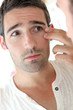 Photo: Man in front of mirrror looking at his wrinkles Man in front of mirrror looking at his wrinkles