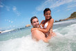Cheerful couple enjoying the waves