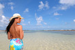 Woman with pareo standing on the beach
