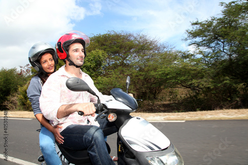 Photo: Couple riding motorbike on a country road Couple riding motorbike on a country road