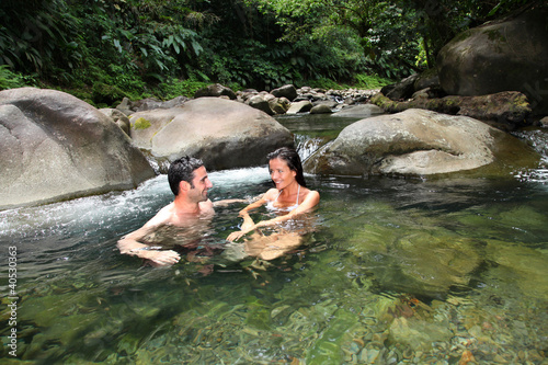 Foto: Couple having a bath in fresh river water Couple having a bath in fresh river water