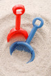 Blue and Red Beach Shovels in The Sand Blue and Red Beach Shovels in The Sand