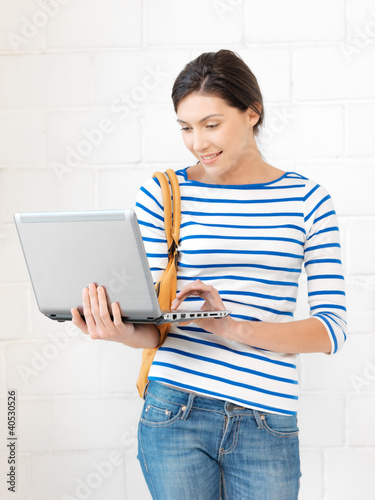 Photo: happy teenage girl with laptop computer happy teenage girl with laptop computer
