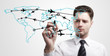 Young business man drawing an airplane routes on world map
