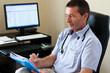 Photo: Doctor Writing On A Document Doctor Writing On A Document