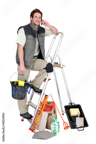 Photo: Tiler surrounded by his equipment Tiler surrounded by his equipment