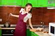 Housewife is preparing soup with book Housewife is preparing soup with book