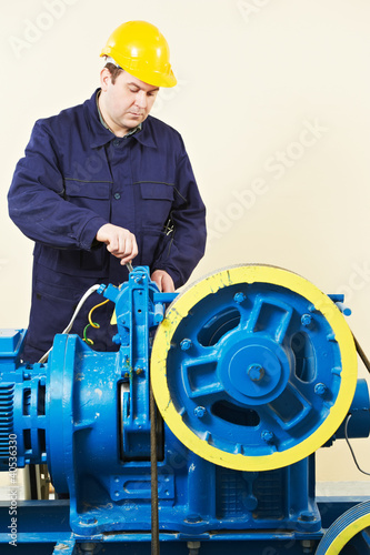 Photo: Machinist tuning elevator brakes mechanism Machinist tuning elevator brakes mechanism