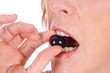 closeup of woman eating grape closeup of woman eating grape
