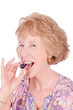 Woman eating a grape