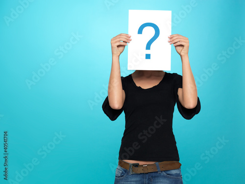 Photo: pretty young woman showing a question mark pretty young woman showing a question mark