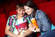 Young couple in cinema watching movie