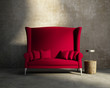 Red loveseat sofa vintage village interior, grunge wall