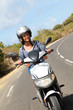 Young woman riding motorbike