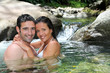 Closeup of cheerful couple bathing in river