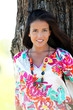 Beautiful woman standing by a tree in countryside Beautiful woman standing by a tree in countryside