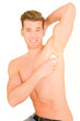 Young man applying deodorant