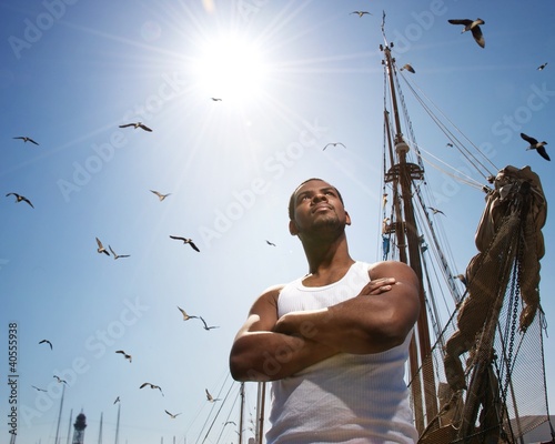 Photo: Handsome afro-american man against boat's mast. Handsome afro-american man against boat's mast.