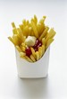 Chips with ketchup and mayo in white fast food box