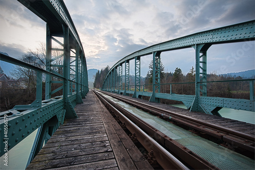 Photo: railway train bridge with cyan painted steel framework railway train bridge with cyan painted steel framework
