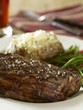 Grilled New York steak with green beans and baked potato