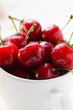 Fresh red cherries in beaker