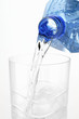Pouring water out of plastic bottle into glass