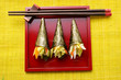 Temaki-sushi on red platter