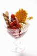 Sundae with raspberry ice cream, cream, wafers & sprinkles