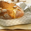 Freshly baked potato bread on tea towel