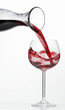 Pouring red wine into glass from carafe